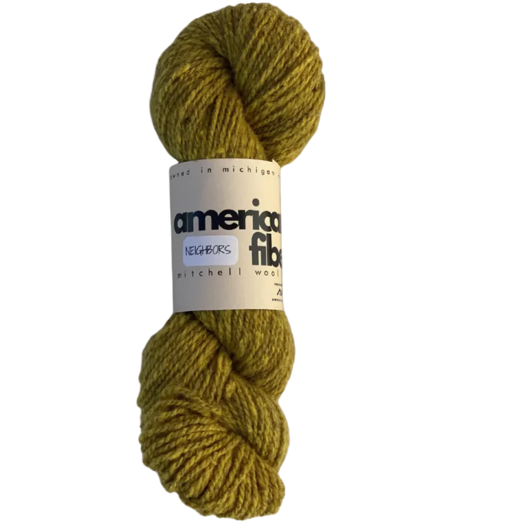 Skein of green yarn with an American Fibers label on a light gray background