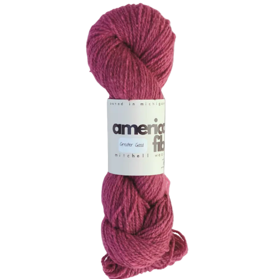 Skein of pink yarn with a label on a gray background