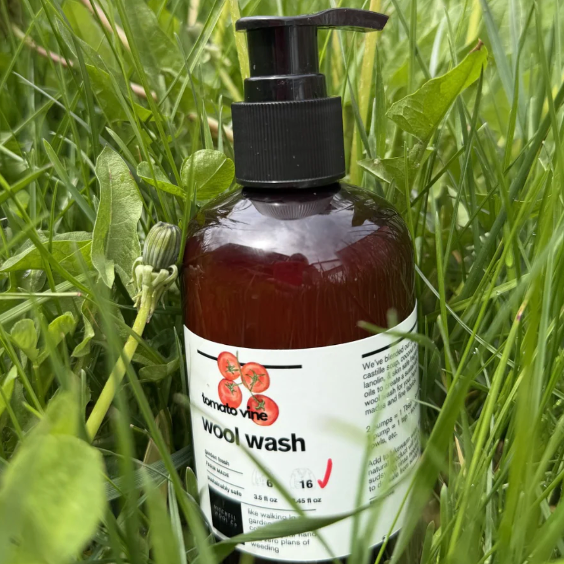 Bottle of wool wash with a pump dispenser on grass