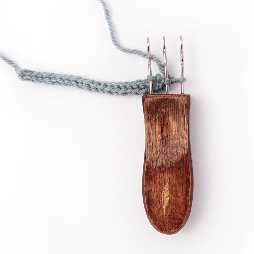 Wooden icord maker with yarn on a white background