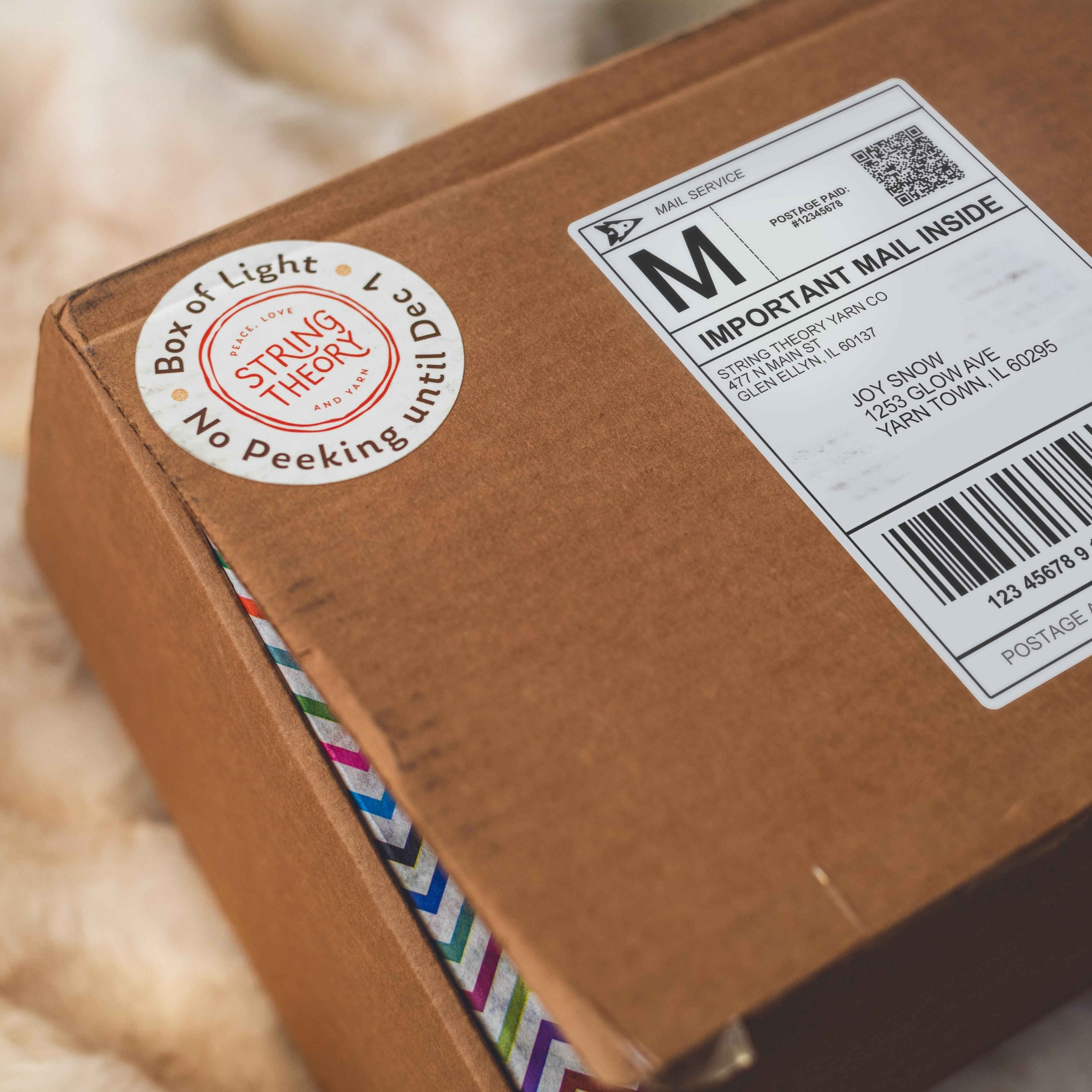 shipping box with sticker that says "Box of Light - no peeking until December 1"