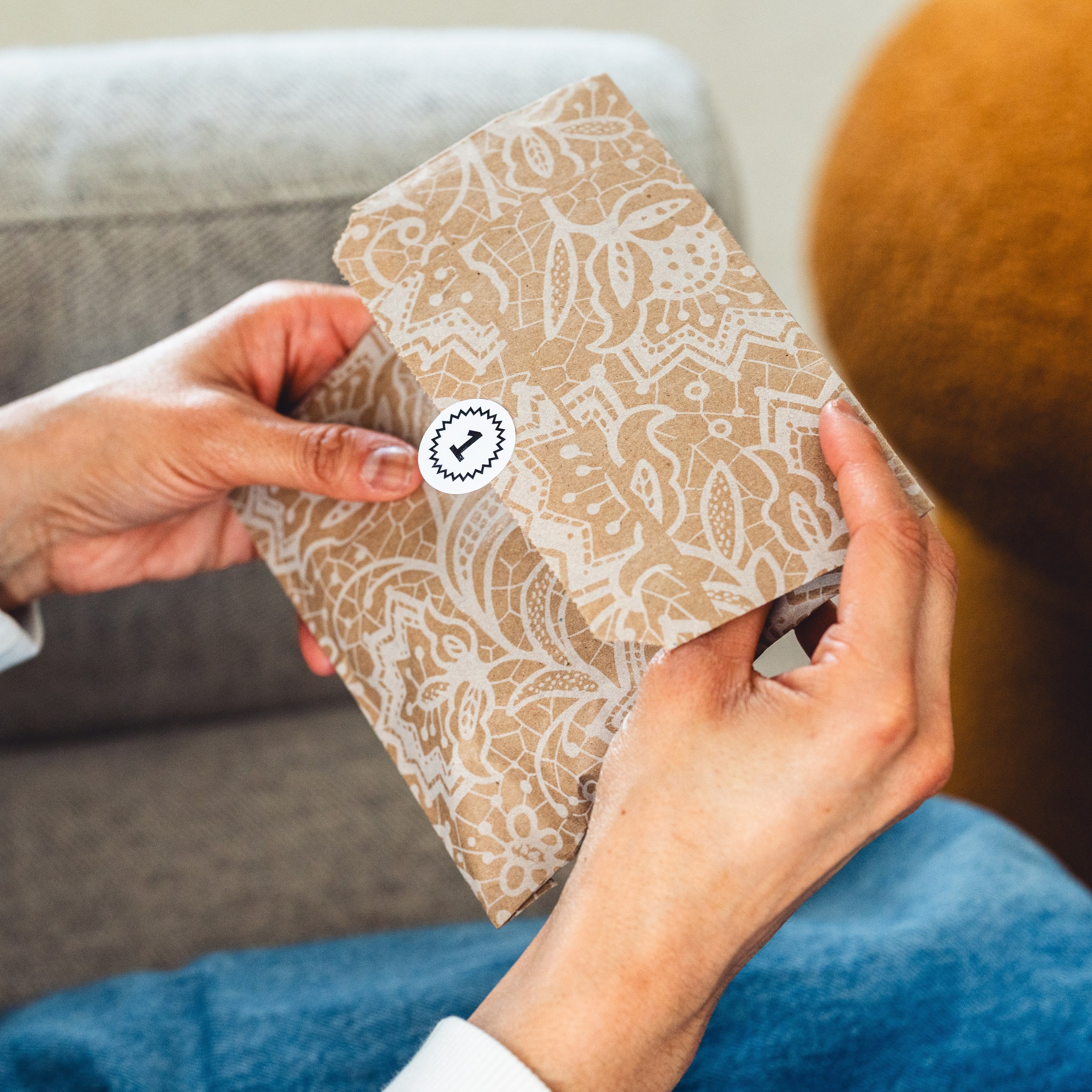 hands opening the first Box of Light envelope.